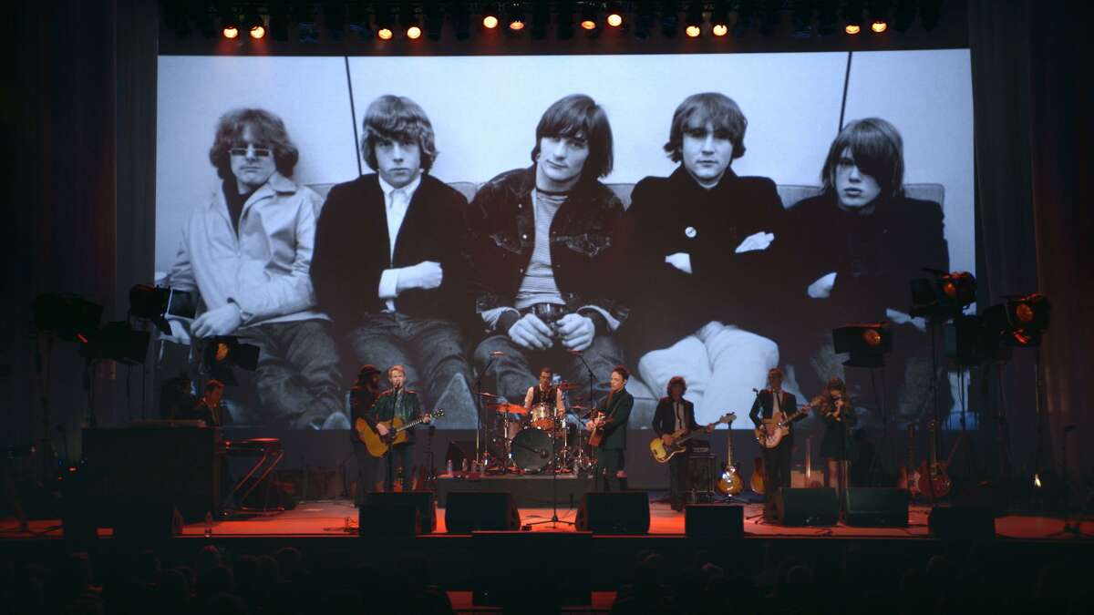 The documentary "Echo in the Canyon" includes scenes from a 2015 concert featuring Jakob Dylan and other contemporary musicians playing cover versions of 1960s pop classics. The group is shown playing in front of a photographic backdrop of the Byrds, one of the seminal groups of the Laurel Canyon music scene of the 1960s. MUST CREDIT: Photo courtesy of Greenwich Entertainment