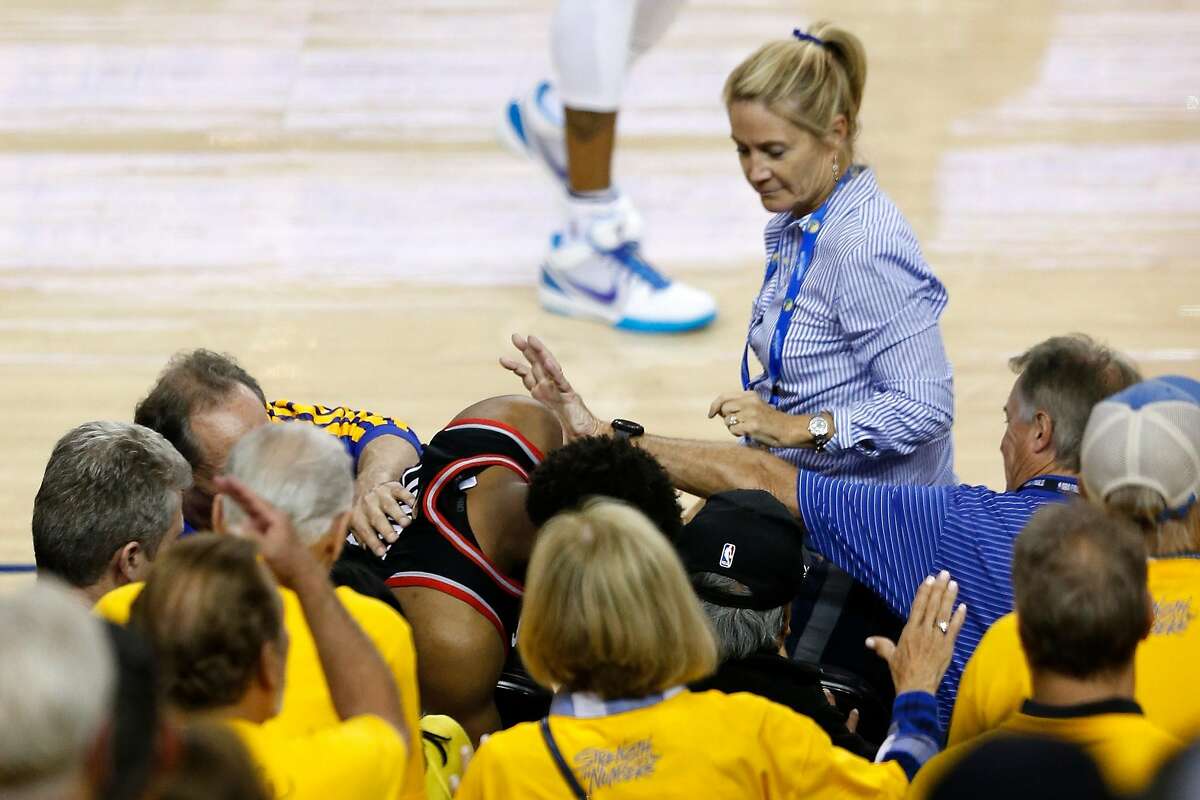OAKLAND, CALIFORNIA - JUNE 05: Kyle Lowry #7 of the Toronto Raptors is pushed by a fan after falling into the seats after a play against the Golden State Warriors in the second half during Game Three of the 2019 NBA Finals at ORACLE Arena on June 05, 2019 in Oakland, California. NOTE TO USER: User expressly acknowledges and agrees that, by downloading and or using this photograph, User is consenting to the terms and conditions of the Getty Images License Agreement. (Photo by Lachlan Cunningham/Getty Images)