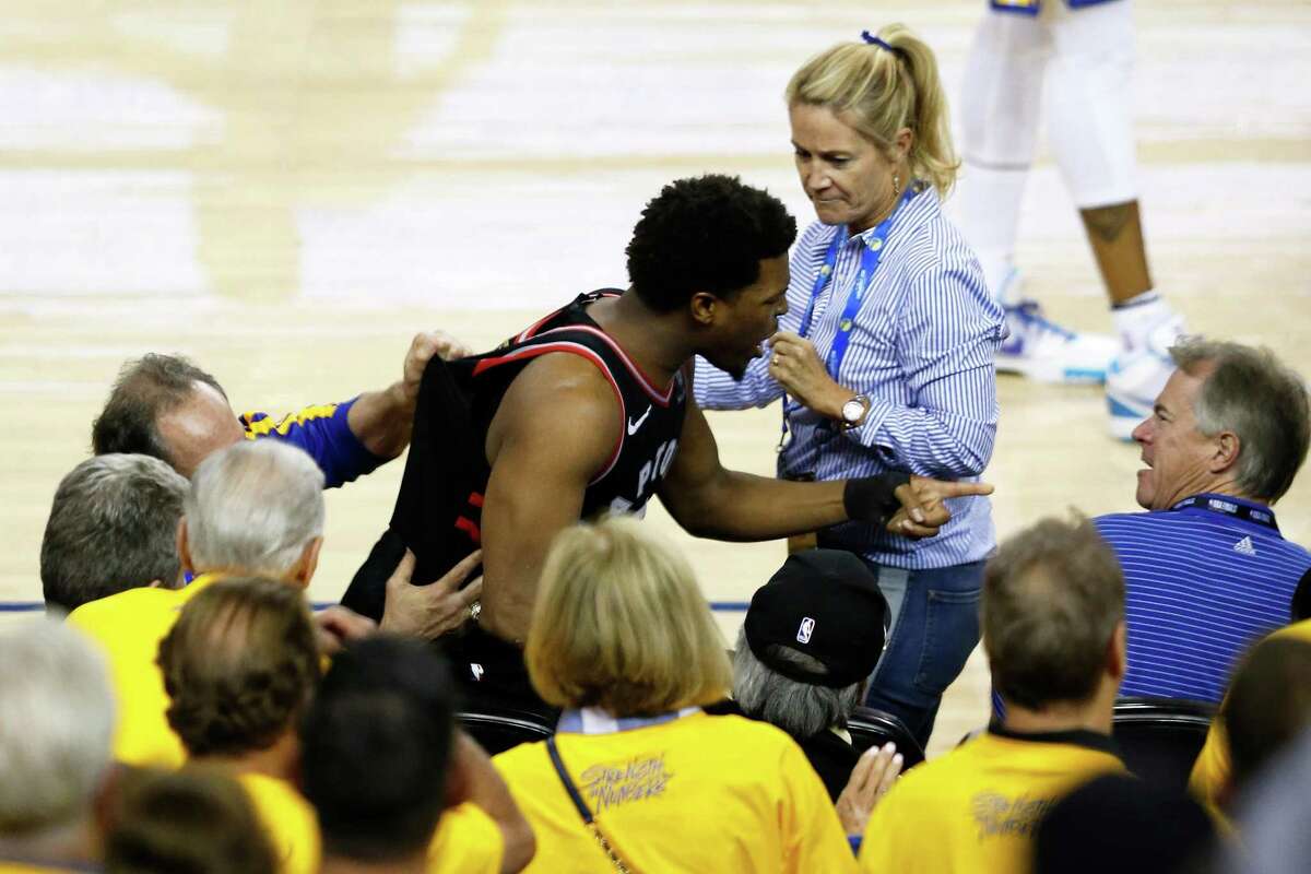 Kyle Lowry of the Toronto Raptors yells at Warriors minority owner Mark Stevens after Stevens shoved him in the shoulder. The incident happened after Lowry collided with two fans while going for a loose ball in the fourth quarter of Game 3 of the NBA Finals at Oracle Arena on Wednesday in Oakland.