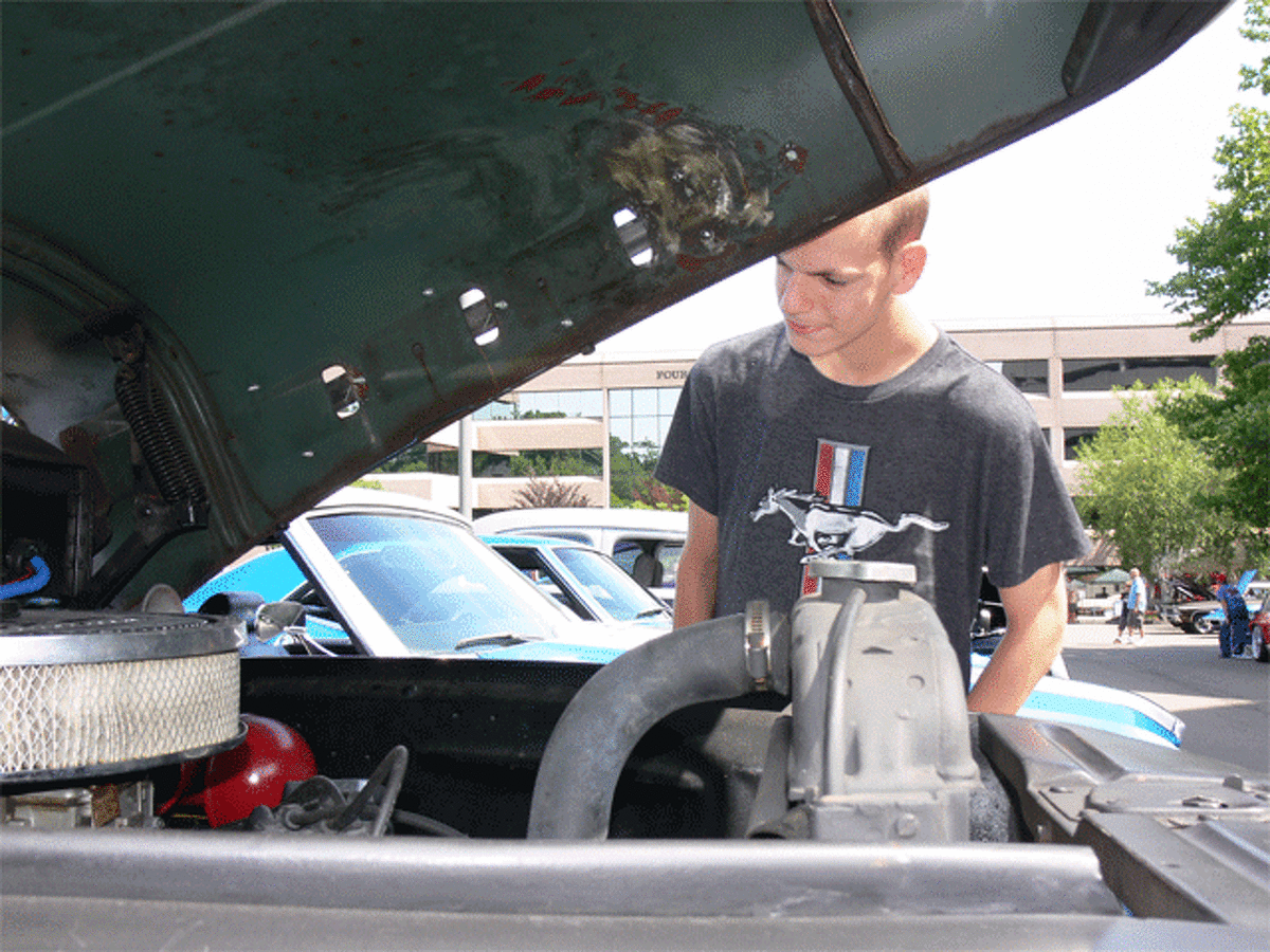 Sean Albright, 16, of Shelton checks under the hood of a 1952 Ford pickup owned by Frank Swarbrick of Stratford.