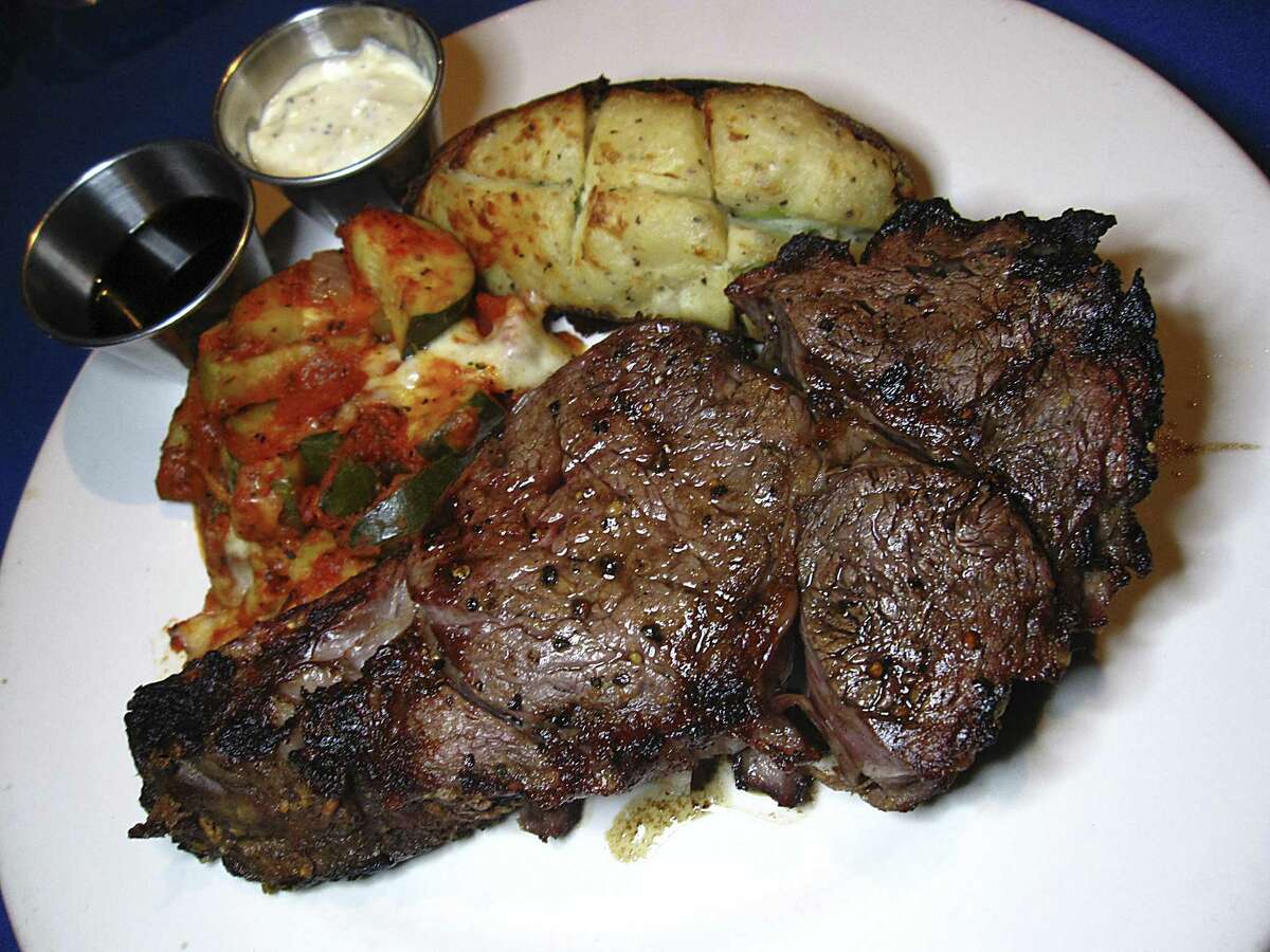 Smoked prime rib is served with a twice-baked potato and squash gratin at The Grey Moss Inn Restaurant.