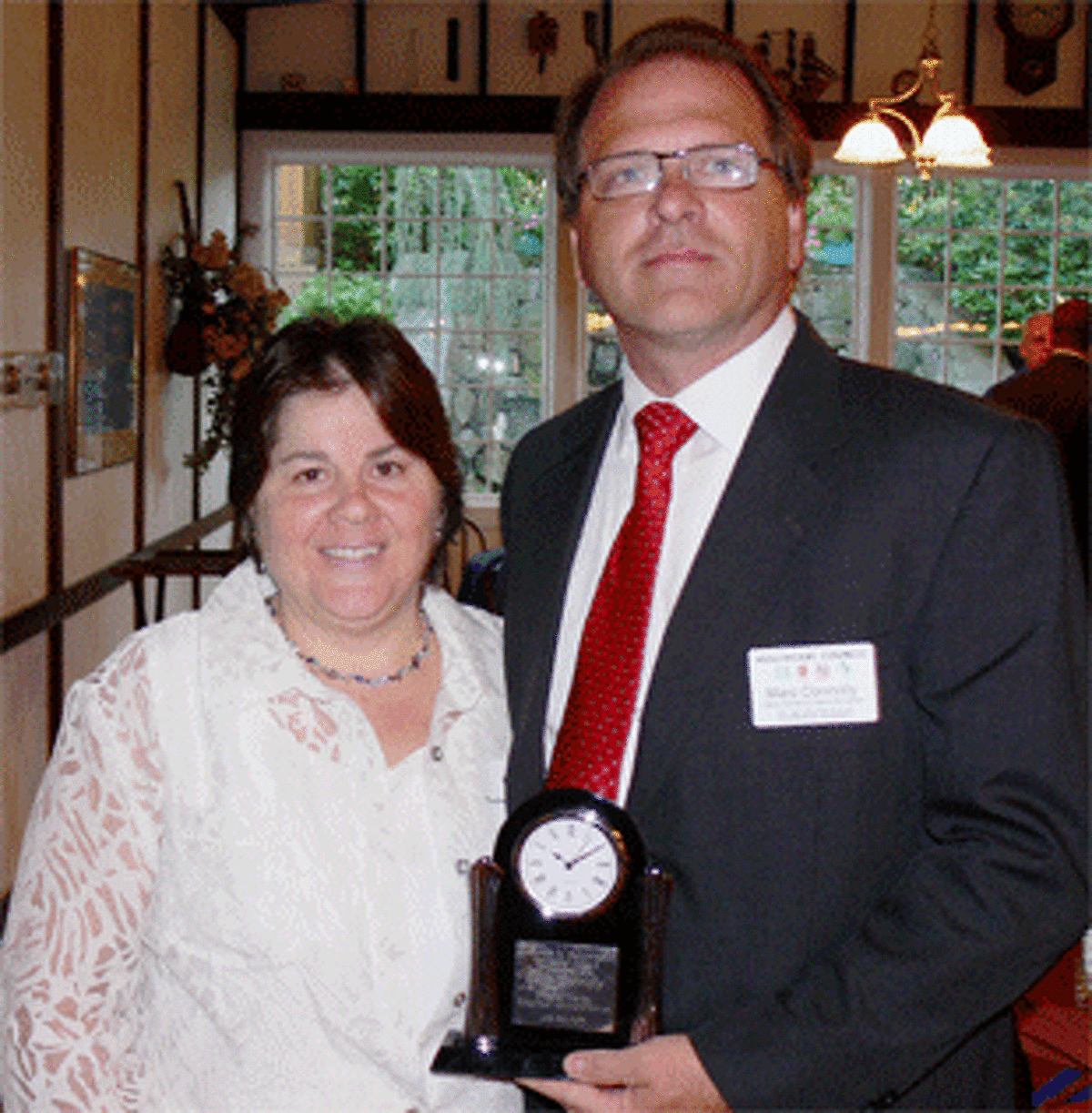 Susan Goodman, the widow of James Goodman, with Marc Connolly holding his award at the Greater Valley Chamber of Commerce event. The award is named after James Goodman.