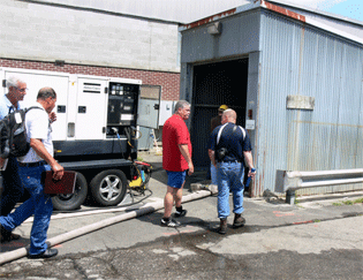 Officials head toward the entrance to the basement where the fire occurred at Latex Foam in Shelton.