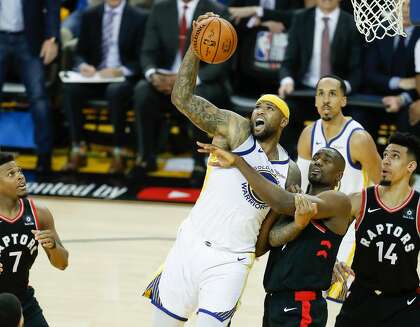 DeMarcus Cousins pulls down a rebound over Serge Ibaka during the 2019 NBA Finals.