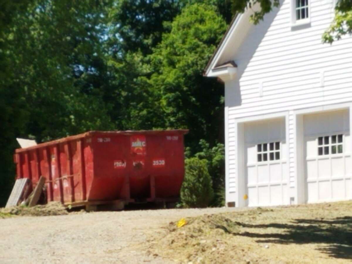 A dumpster outside 61 Sturbridge Hill Road in New Canaan. The property is being developed by Fotis Dulos’ company, the Fore Group, and was the target of a state police search on Wednesday.