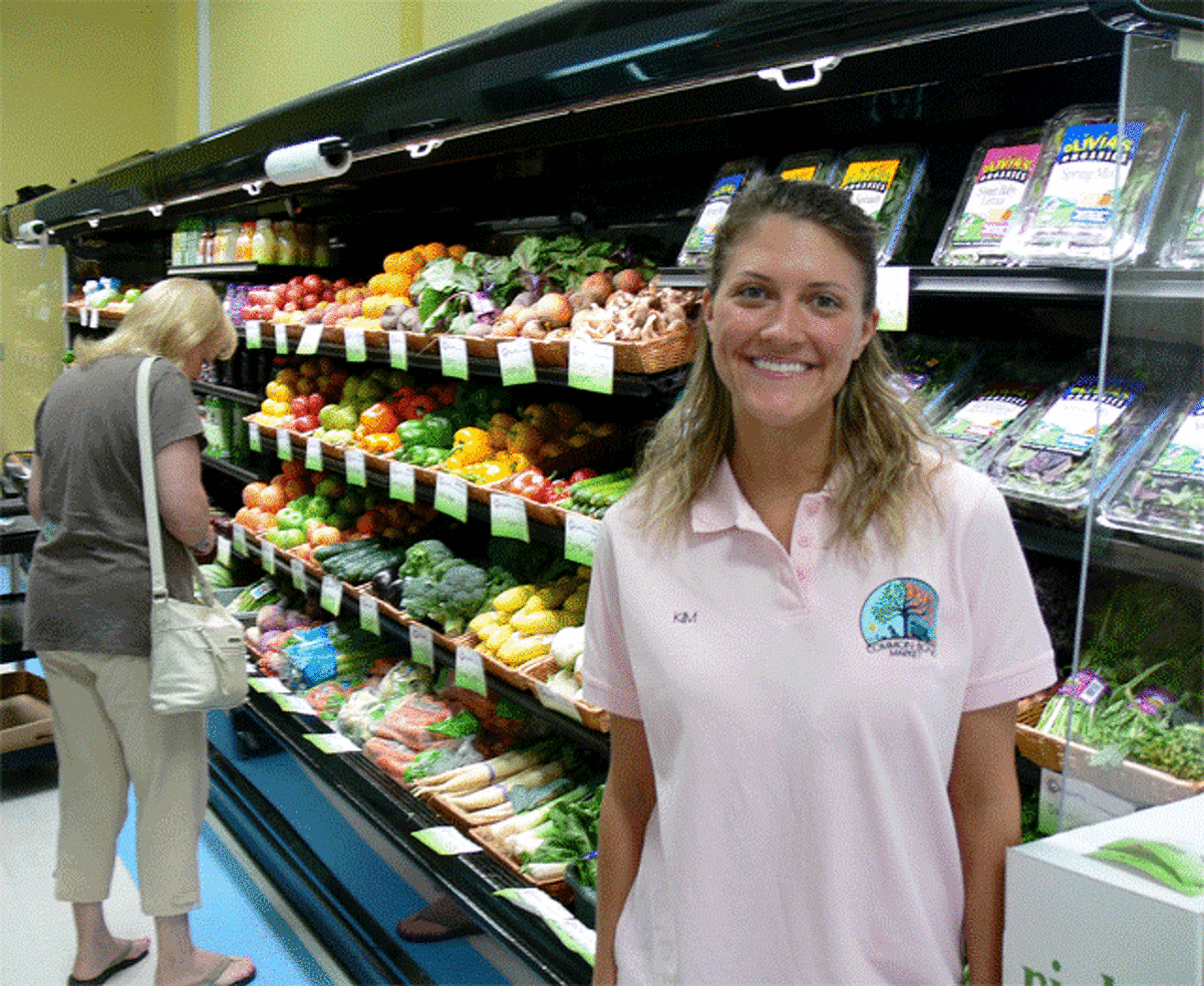 Kim Osborne, general manager of the Common Bond Market, stands in front of the produce area at the new store in Shelton.