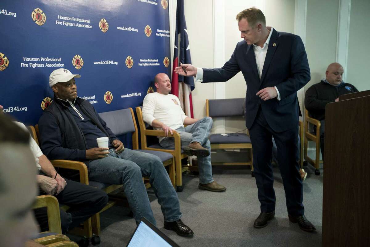 Marty Lancton, president of the Houston Professional Firefghters Association, turns from the podium to talk to City Councilman Dwight Boykins while leading a union meeting at the IAFF Local 341 union hall on Thursday, Feb. 7, 2019, in Houston.