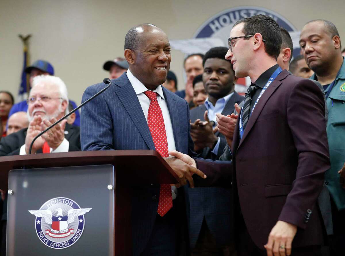 Mayor Sylvester Turner shakes hands with Joe Gamaldi, president of the Houston Police Officers' Union, during a Jan. 31, 2018, news conference. ( Karen Warren / Houston Chronicle )