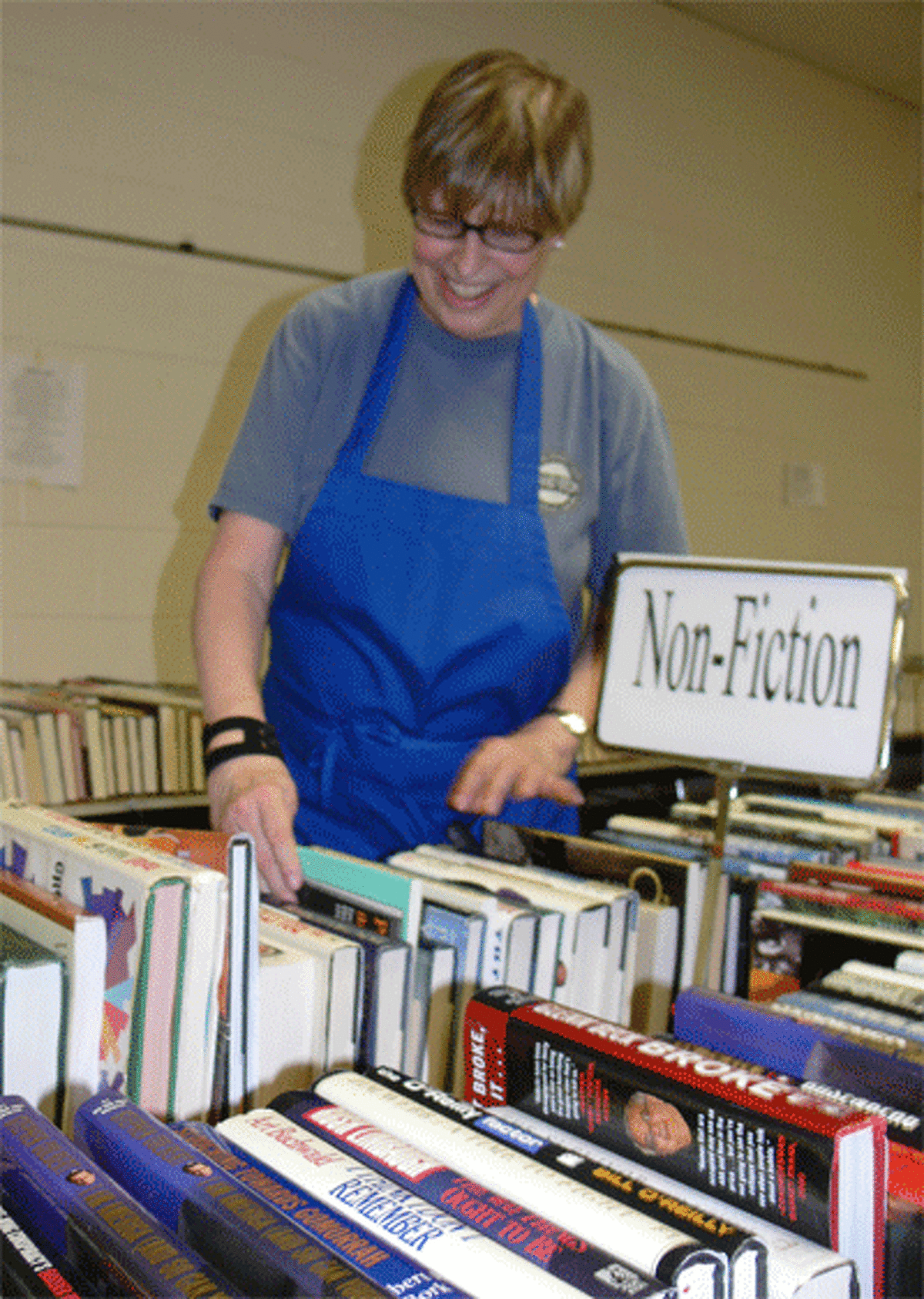 Volunteer Cathy Reeve helps organize books at the book sale. Reeve is a Library Friends member.