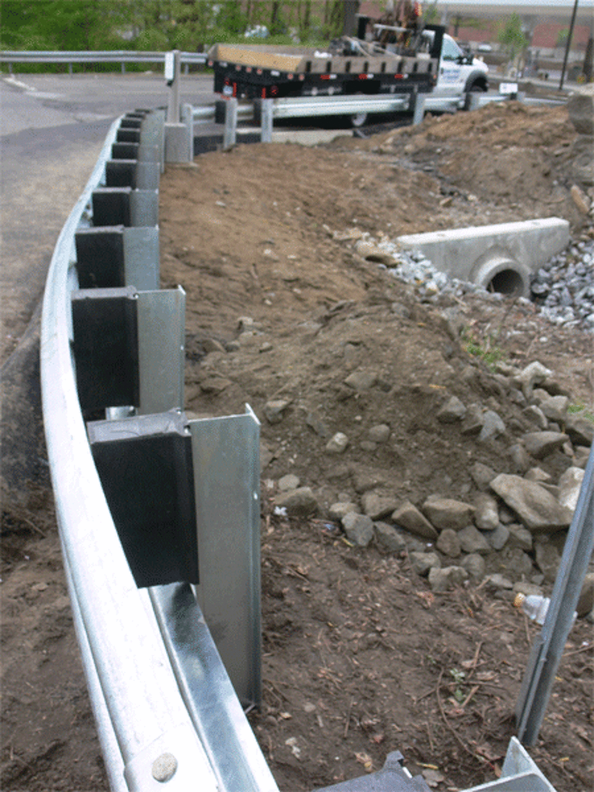 The new guardrail on Bridgeport Avenue, looking north toward the small brook and the shopping center entrance.