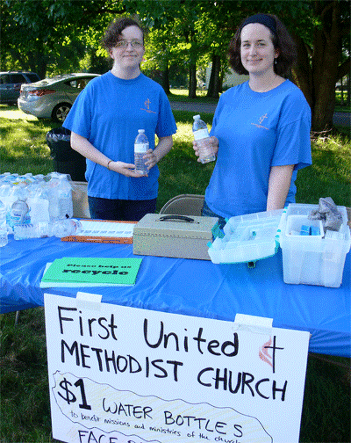 Alyssa Wood, left, and Nicole Misencik, both of Shelton and First United Methodist Church of Shelton members, staff the carnival’s water and face-painting table on opening night.