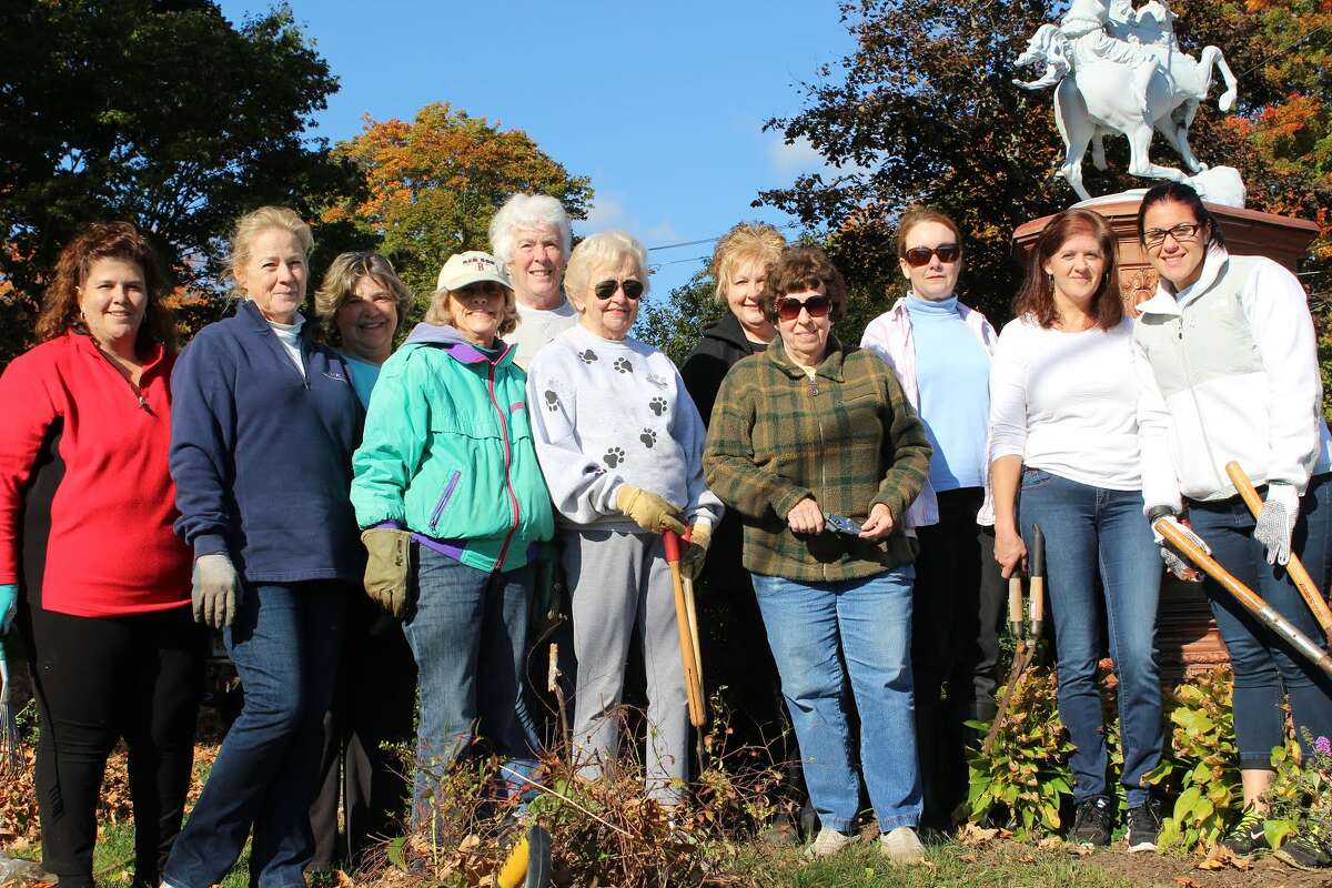 The Olde Ripton Garden Club stands with volunteers from Gexpro who are part of a Community Outreach Program while cleaning up the Huntington Green. - Aaron Berkowitz photo
