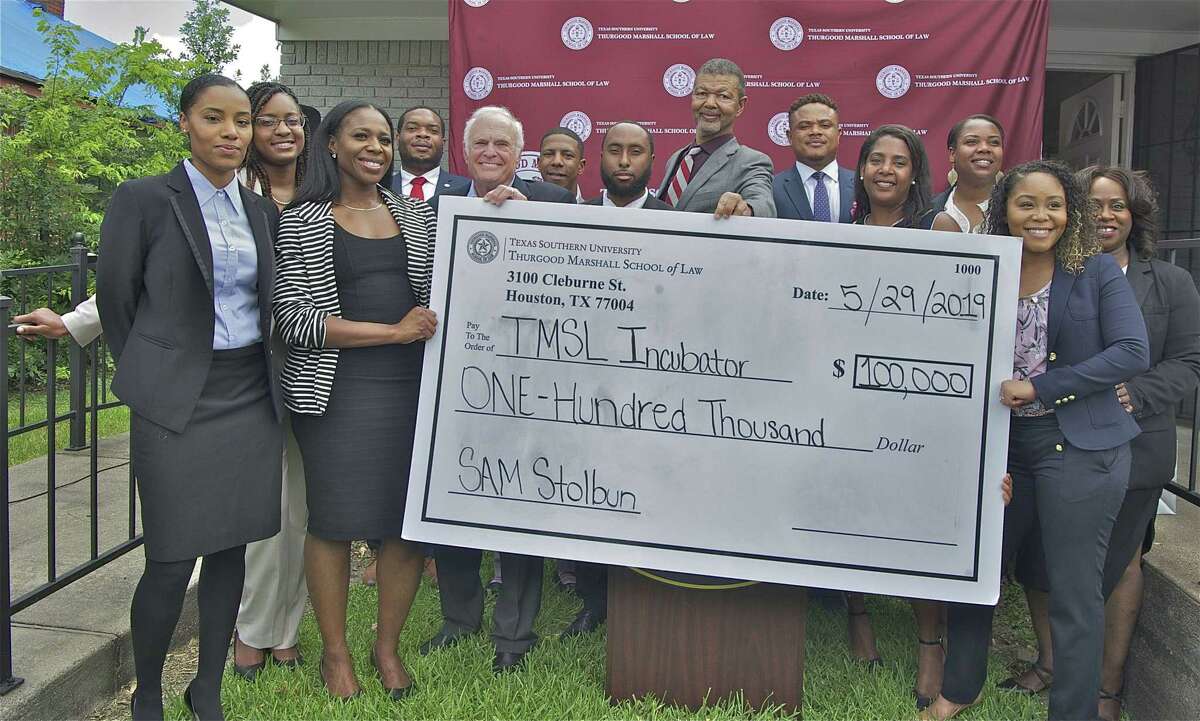 Taren Marsaw, left, Sam Stolbun, fifth from the left, and Dean Gary Bledsoe, middle, celebrate the opening of the Thurgood Marshall School of Law Legal Entrepreneurship Incubator in Houston's Third Ward. The incubator will assist recent graduates in starting community-oriented law practices with the assistance of the NAACP and other graduates of Texas Southern University. Sam Stolburn, a Houston lawyer and business person, contributed $100,000 to help start the incubator.