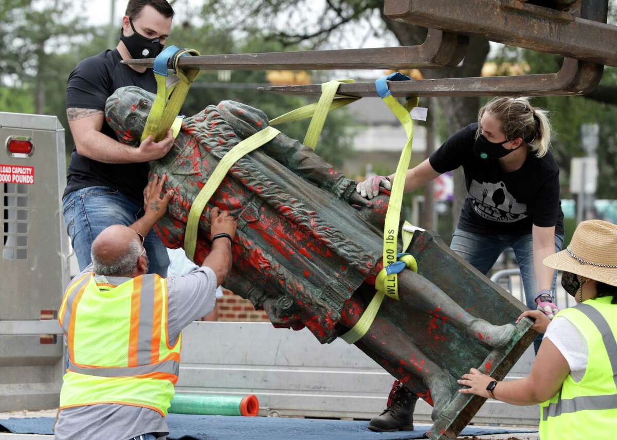 Workers remove the defaced statue of Christopher Columbus, on Wednesday , July 1, 2020.