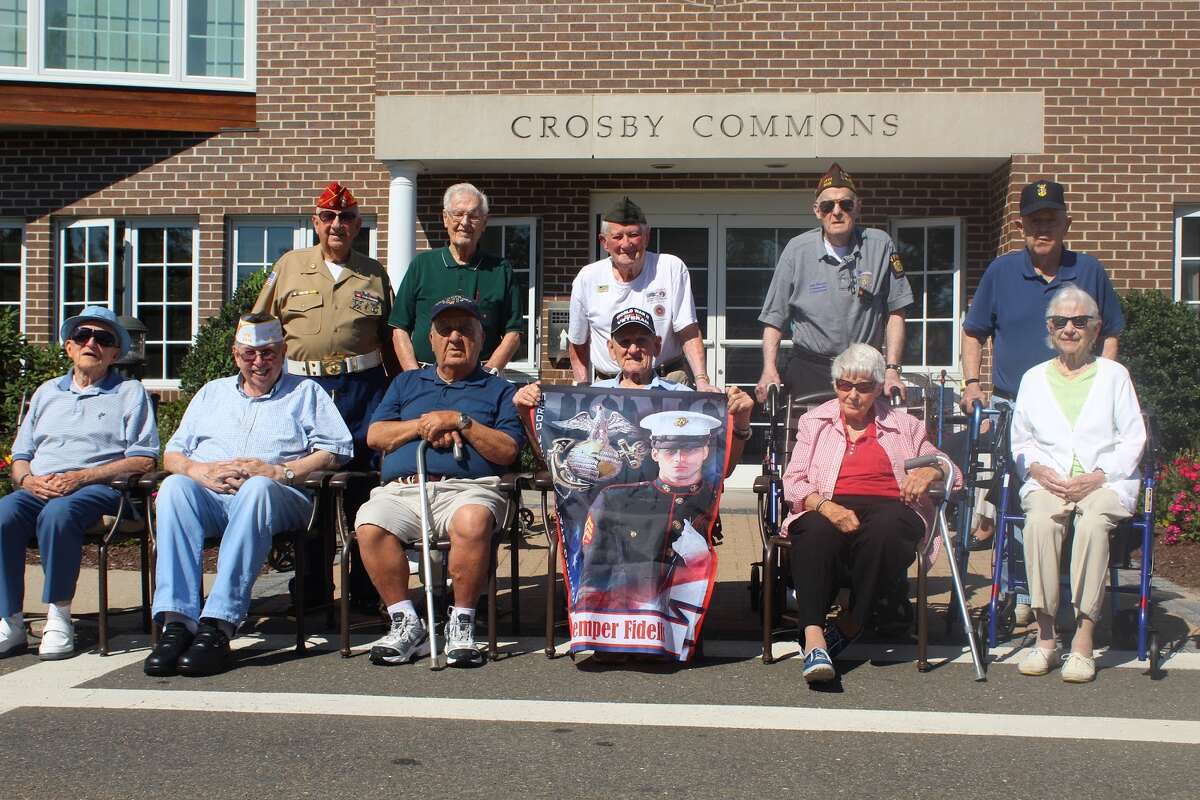 All of the residents who are veterans at Wesley Village’s Crosby Commons section community celebrated a Flag Dedication Ceremony in front of their main building (Aaron Berkowitz photo)