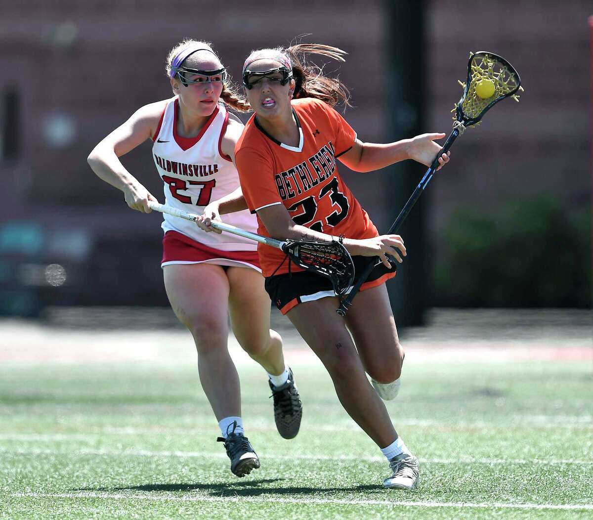 Bethlehem's Ella Stewart, right, beats the defense of Baldwinsville's Emma States during a Class A semifinal at the NYSPHSAA Girls Lacrosse Championships in Cortland, N.Y., Friday, June 7, 2019. Bethlehem’s season ended with a 15-14 overtime loss to Baldwinsville-III. (Adrian Kraus / Special to the Times Union)