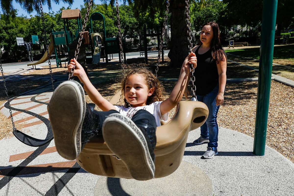 Annette Rivero (right) watches as her daughter Henny, 5, swings at the park in San Jose, California, on Tuesday, June 4, 2019.