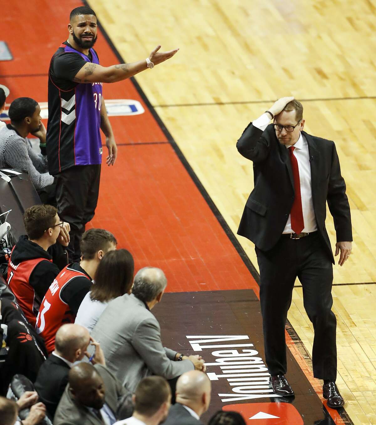 Drake and Toronto Raptors’ coach Nick Nurse react in the second quarter during game 1 of the NBA Finals between the Golden State Warriors and the Toronto Raptors at Scotiabank Arena on Thursday, May 30, 2019 in Toronto, Ontario, Canada.