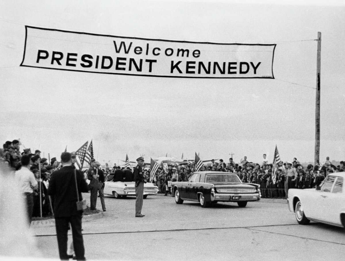 President John F Kennedy and his motorcade are greeted with "Welcome President Kennedy" sign as he arrives in Houston on Sept. 12, 1962.