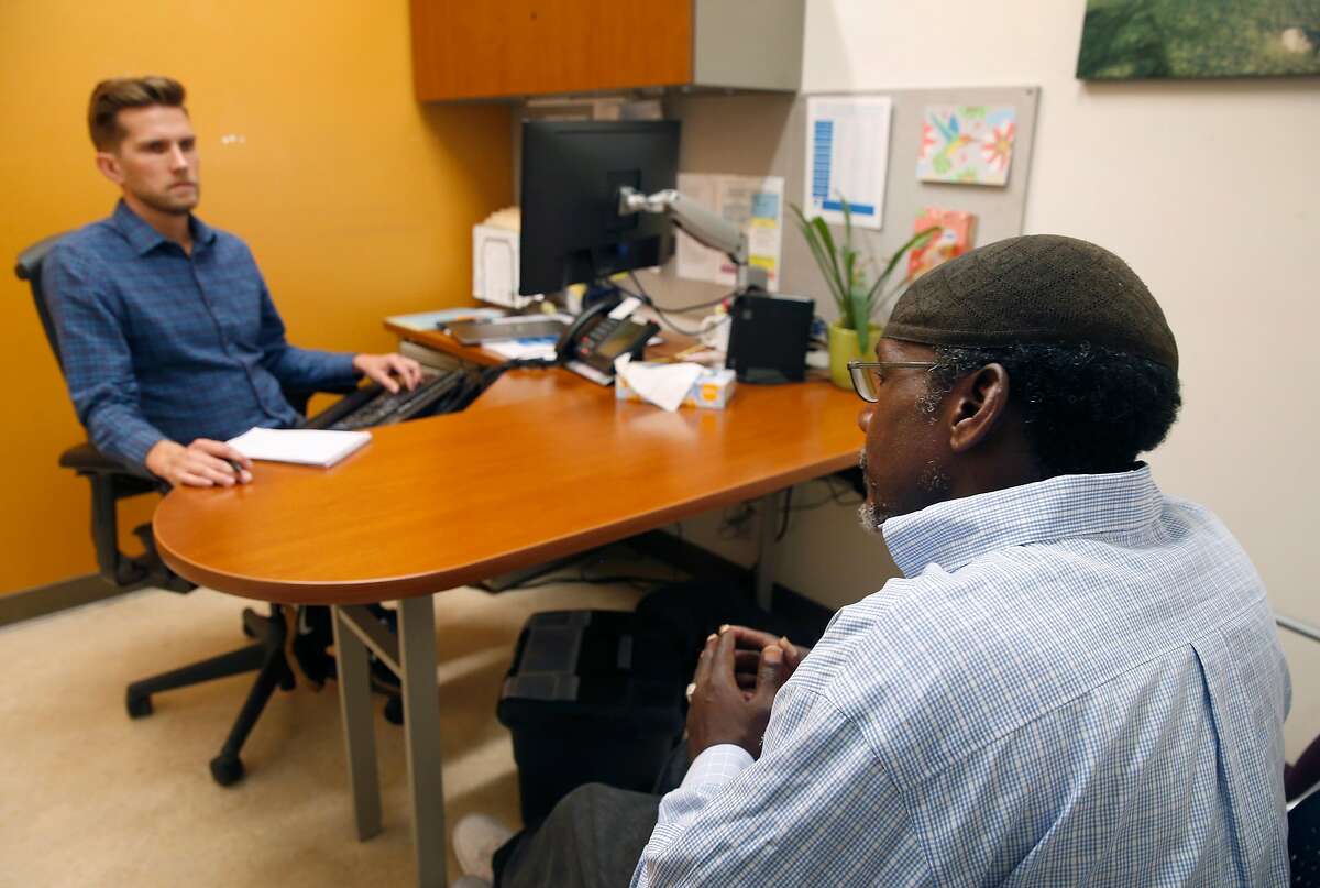 Robert Reed (right) meets with Dr. Jeffrey Seal, a physician and the medical director of the Alameda County Health Care for the Homeless clinic, in Oakland, Calif. on Thursday, June 6, 2019. A dozen mayors have sent a letter to the Board of Supervisors urging the release of more funds to handle the county's growing homeless population.