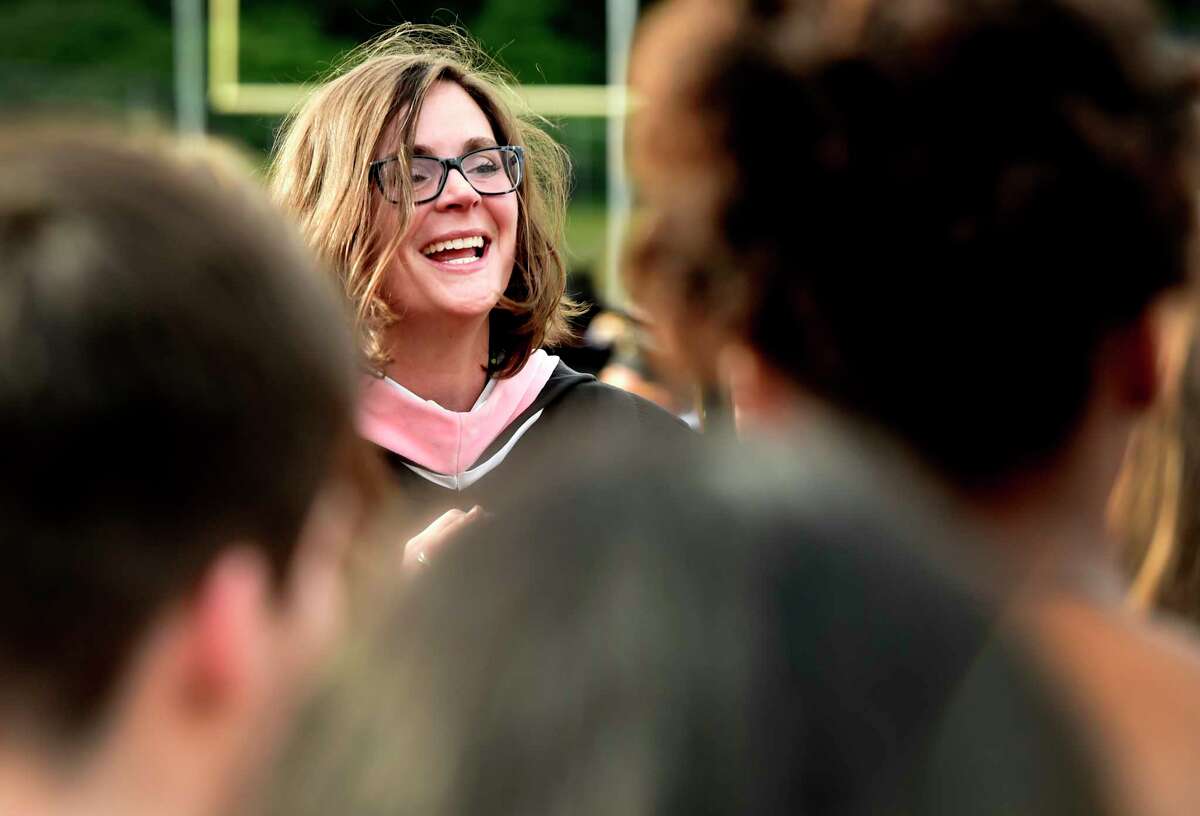 Milford, Connecticut - Friday, June 7, 2019:Mrs. Kelly Jones, the Jonathan Law H.S. Choir Director, leads the Jonathan Law H.S. Concert Choir during the Jonathan Law High School of Milford 2019 Graduation exercises Friday evening at the Law H.S. football field.