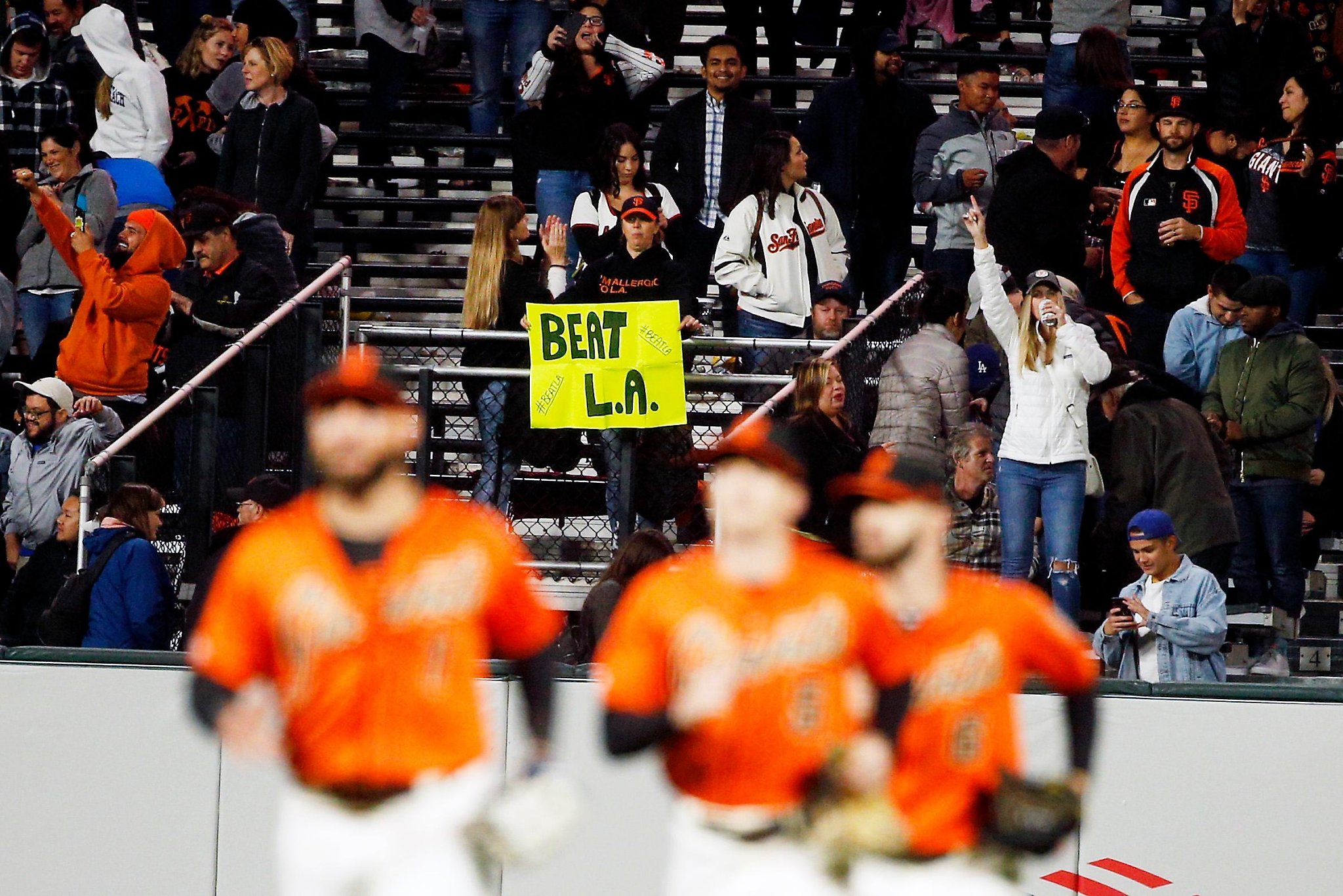 Wearing a Madison Bumgarner jersey, Adam Serrano and his son Christian, 5  1/2, settle into their seats for the Giants game against the Chicago Cubs  at Oracle Park in San Francisco, Calif.