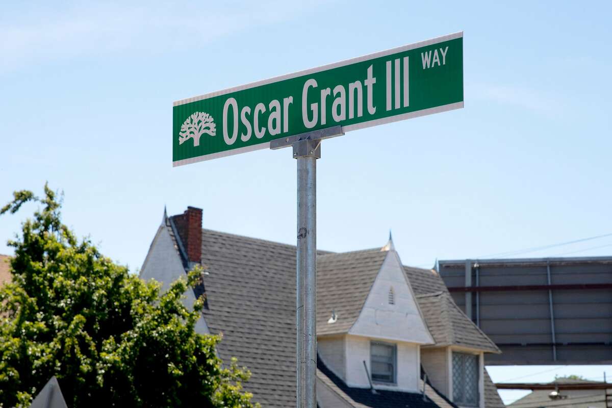A street sign marking the newly-minted Oscar Grant III Way, honoring the late Oscar Grant, is unveiled at Fruitvale BART Station in Oakland, Calif. Saturday, June 8, 2019.