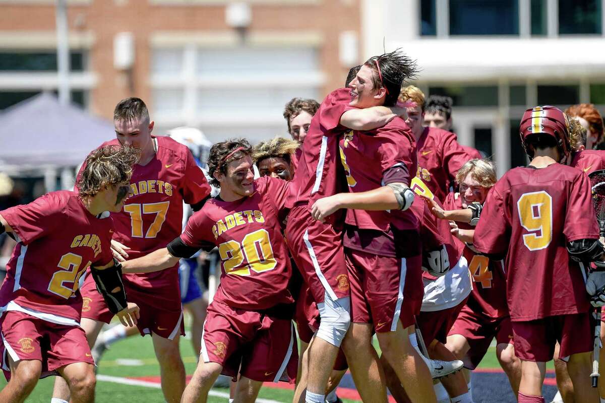 Members of the St. Joseph boys lacrosse team celebrate their 9-3 victory over Bacon Academy Saturday in the CIAC Class S state championship game.
