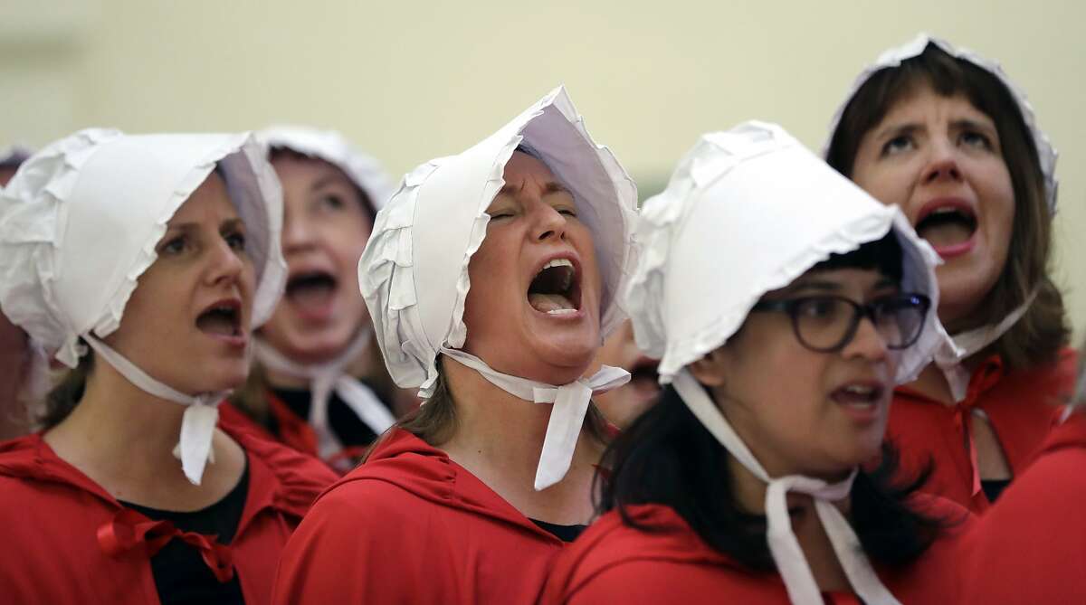 FILE - In this Tuesday, May 23, 2017 file photo, activists dressed as characters from "The Handmaid's Tale" chant in the Texas Capitol Rotunda as they protest SB8, a bill that would require health care facilities, including hospitals and abortion clinics, to bury or cremate any fetal remains whether from abortion, miscarriage or stillbirth, and they would be banned from donating aborted fetal tissue to medical researchers in Austin. Tissue left over from elective abortions has been used in scientific research for decades, and is credited with leading to lifesaving vaccines and other advances. (AP Photo/Eric Gay)