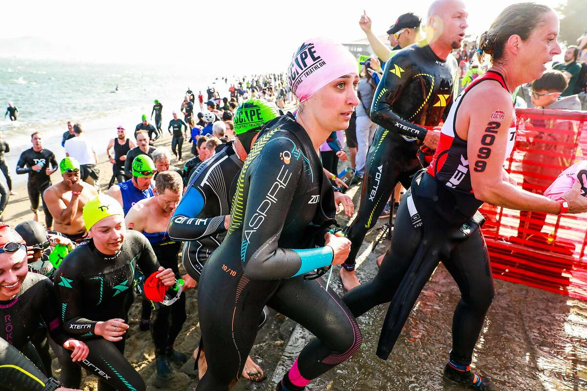 Competitors run up a stairwell after completing the swimming portion of the 39th annual Escape from Alcatraz Triathalon in San Francisco, California, on Sunday, June 9, 2019. Over 2,000 athletes swam the 1.5 miles to shore followed by an 18-mile bike ride and an 8-mile run through San Francisco. The race is considered one of the oldest and most difficult triathlons with many elite participants.