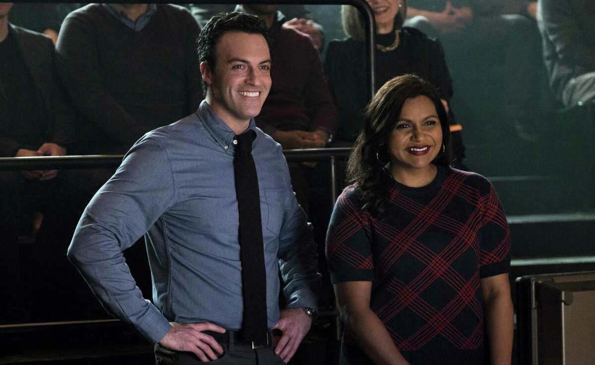 This image released by Amazon Studios shows Reid Scott, left, and Mindy Kaling in a scene from "Late Night." (Emily Aragones/Amazon Studios via AP)