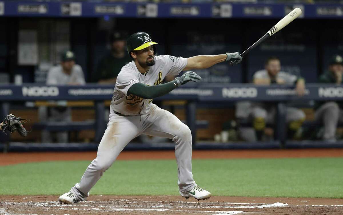 Oakland Athletics' Marcus Semien singles off Tampa Bay Rays starting pitcher Charlie Morton during the third inning of a baseball game Monday, June 10, 2019, in St. Petersburg, Fla. (AP Photo/Chris O'Meara)