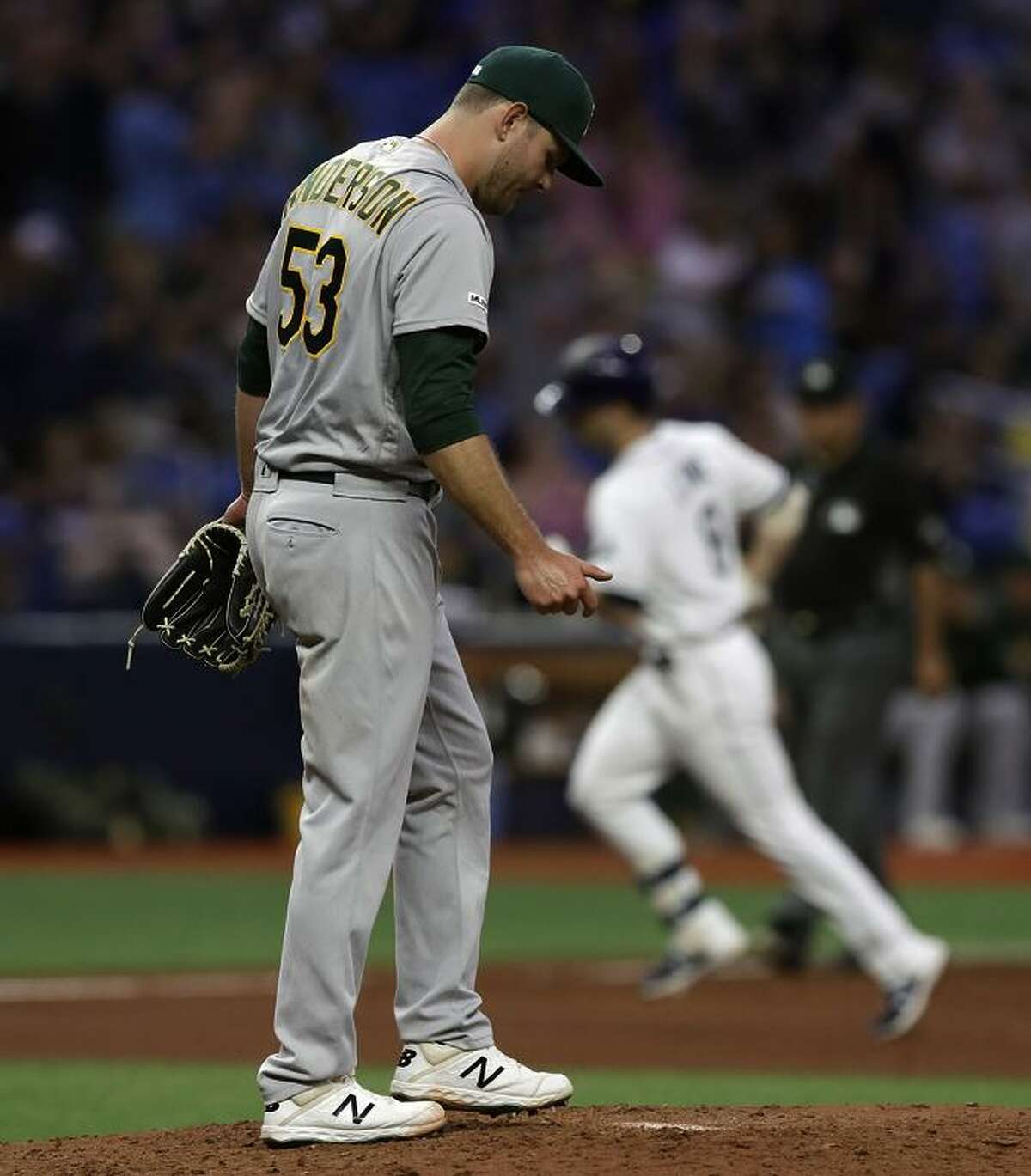A’s pitcher Tanner Anderson allowed a two-run home run to the Rays’ Brandon Lowe (in background) in the sixth inning. Anderson was making his A’s debut after spending the first few weeks of the season at AAA Las Vegas.