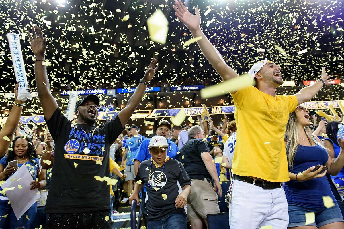 Confetti rains down on cheering fans following the Warriors win during a watch party for Game 5 of the NBA Finals between the Golden State Warriors and the Toronto Raptors at Oracle Arena in Oakland, Calif., on Monday, June 10, 2019.