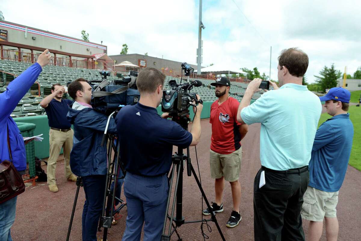 New ValleyCats manager, Ozney Guillen, center right, meets the media outside the ValleyCats dugout on Tuesday, June 11, 2019, at Joseph L. Bruno Stadium in Troy, N.Y. (Catherine Rafferty/Times Union)