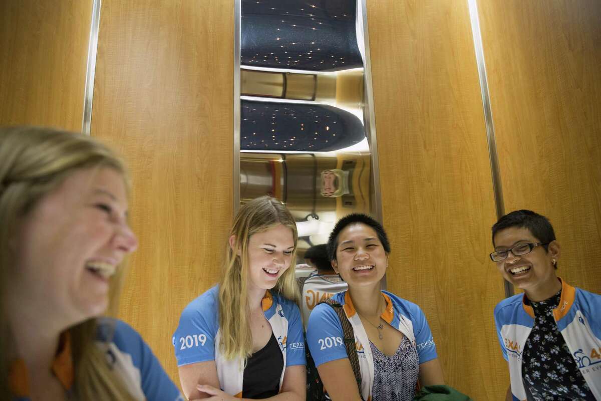 Clare Crotty, from left, Jordan York, Madeline Yuan and Rachel Lopes, UT Austin cyclists from the 2019 Texas 4000 team ride an elevator at the Texas Children's Hospital in Houston, Wednesday, June 5, 2019. The Texas 4000 team, which hopes to raise money for cancer research and support services, toured the Texas Children's Hospital and presented a $25,000 check to support its Retiro de Renovación program.