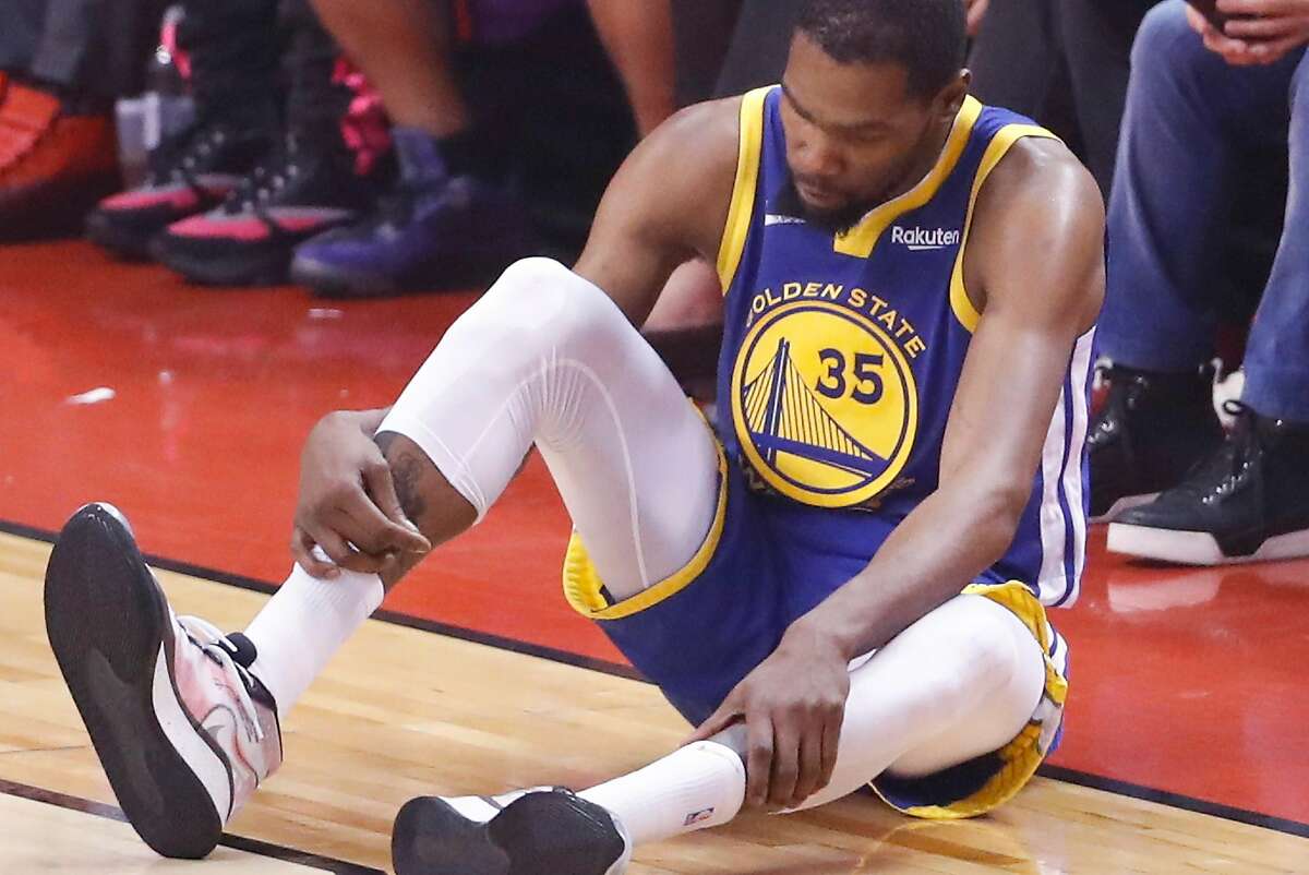 Golden State Warriors’ Kevin Durant checks his right leg in the second quarter during Game 5 of the NBA Finals.