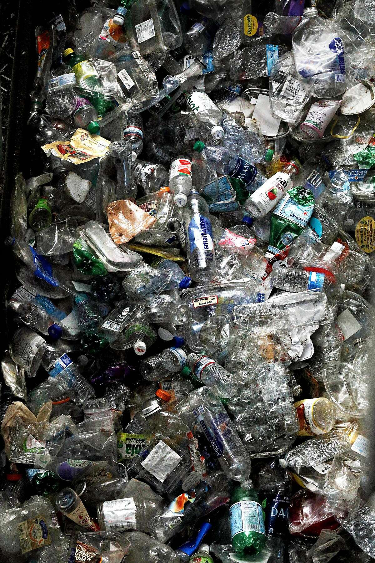 Plastic bottles ready to be turned into bales are seen in a high density baler at Recology�s Recycle Central on Tuesday, June 11, 2019 in San Francisco, Calif.