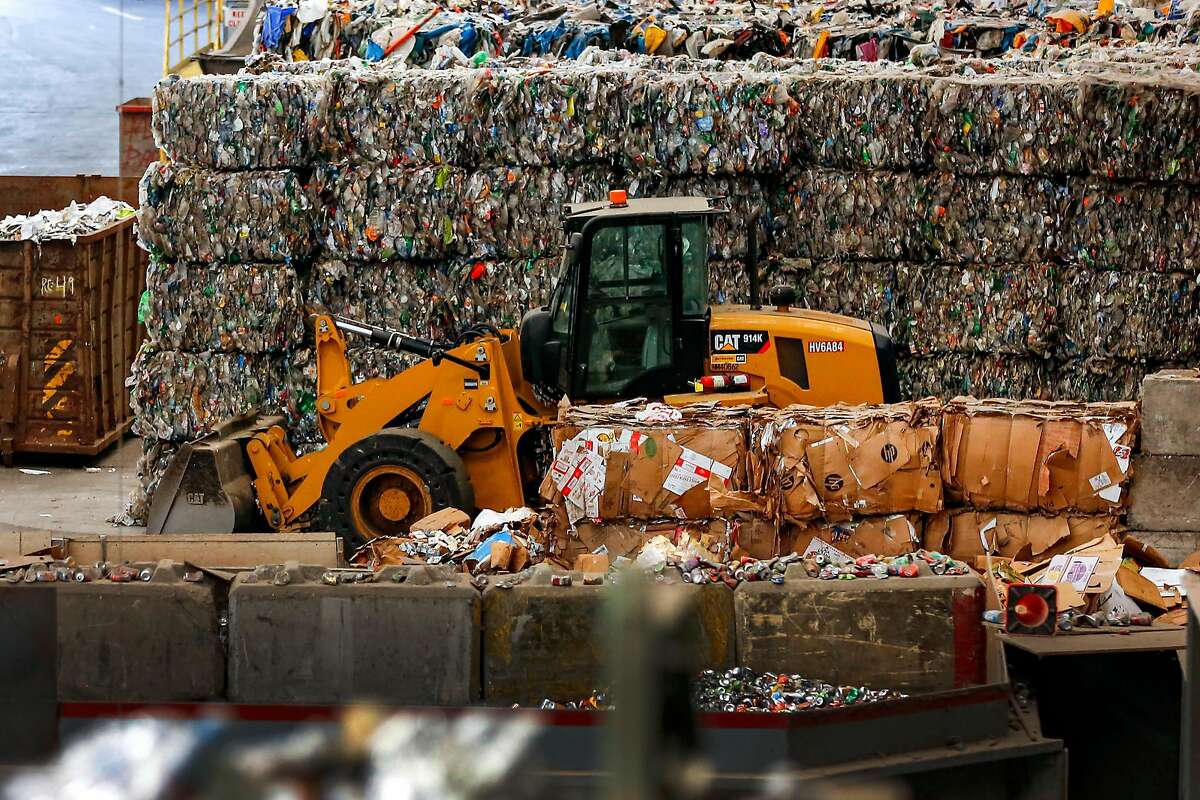 A wall of baled plastic sit behind a excavator in the back of the house at Recology's Recycle Central on Tuesday June 11, 2019 in San Fransisco, Calif. This wall is one day's worth of plastic and water bottles for San Fransisco.