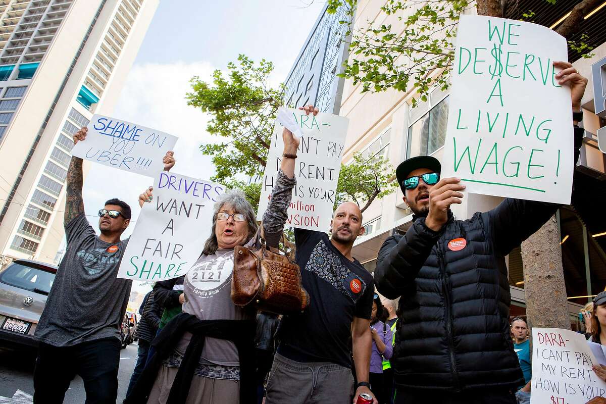 From left: Marcos, Alison Datz, Rafael and Vinicius protest outside Uber headquarters on Wednesday, May 8, 2019, in San Francisco, Calif. The men respectfully declined to give their last name.