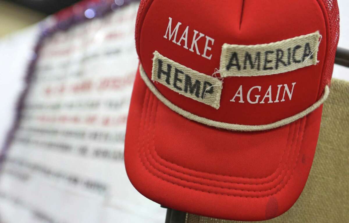 In this June 14, 2018, photo a "Make America Great Again" hat has been altered and put on display at the Texas Hemp Industries Association booth at the 2018 Texas GOP Convention in San Antonio. Texas this month will remove hemp from its list of controlled substances. The Dallas Morning News reports the Texas Department of State Health Services, as of Friday, will no longer classify hemp as a Schedule I drug, a highly restricted group of substances that includes LSD, heroin and cocaine. (Louis DeLuca/The Dallas Morning News via AP)