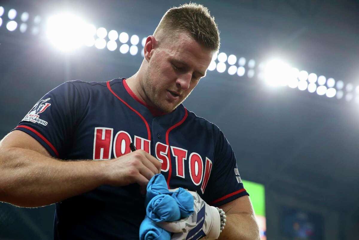 Houston Texans defensive lineman J.J. Watt signs t-shirts to throw into the stands during the J.J. Watt Foundation Charity Classic at Minute Maid Park Saturday, May 4, 2019, in Houston. The foundation’s mission is to provide funding for middle schools across the country that have insufficient or no funding for after-school athletic programs.