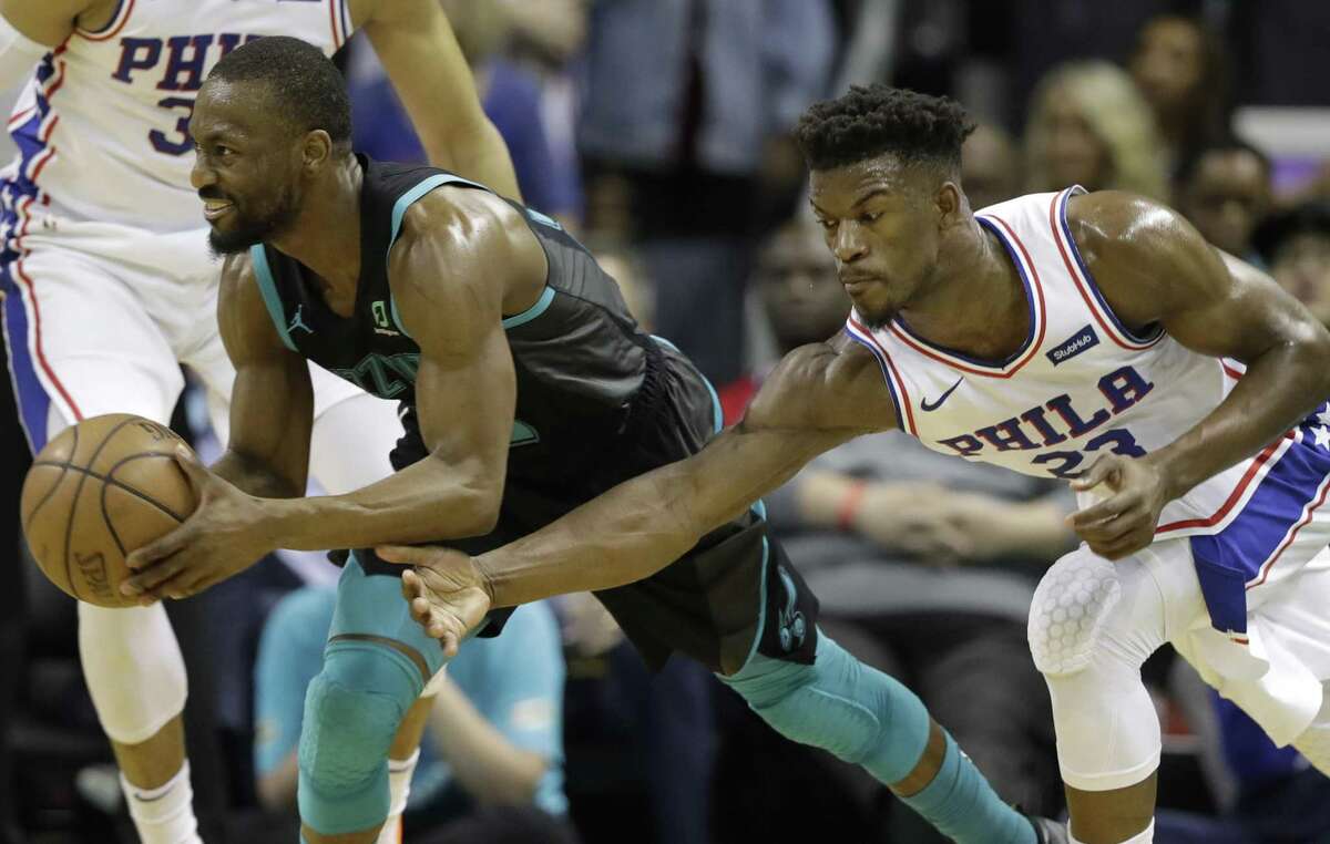Philadelphia 76ers' Jimmy Butler (23) reaches in on Charlotte Hornets' Kemba Walker (15) during the second half of an NBA basketball game in Charlotte, N.C., Tuesday, March 19, 2019. Jimmy Butler and Kemba Walker will be free agents in the 2019 off-season.