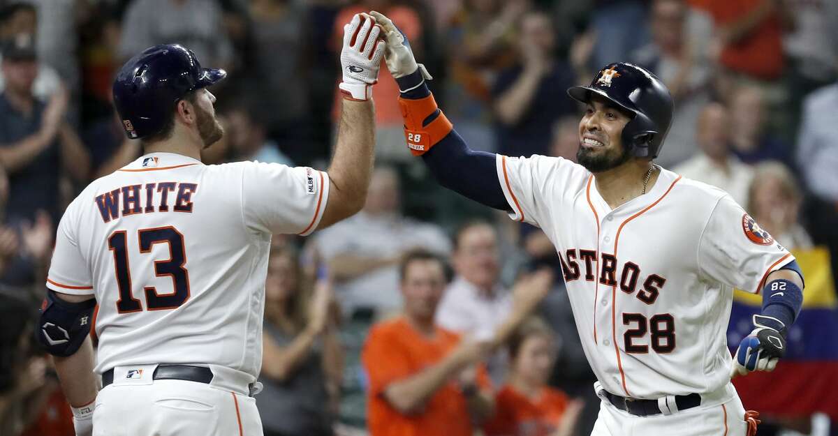 Houston Astros Robinson Chirinos (28) celebrates with Tyler White (13) after hitting his two-run home run during the seventh inning of an MLB baseball game at Minue Maid Park, Tuesday, June 11, 2019.