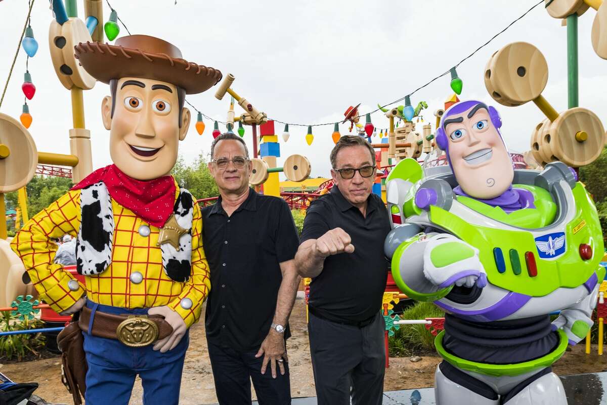 In this Handout provided by Disney Resorts, Stars from DisneyPixars Toy Story 4 Woody (in costume), Tom Hanks (2nd-L), Tim Allen (2nd-R) and Buzz Lightyear (in costume) appear with characters from the film inside Toy Story Land at Disney's Hollywood Studios at Walt Disney World Resort on June 8, 2019 in Lake Buena Vista, Fla.