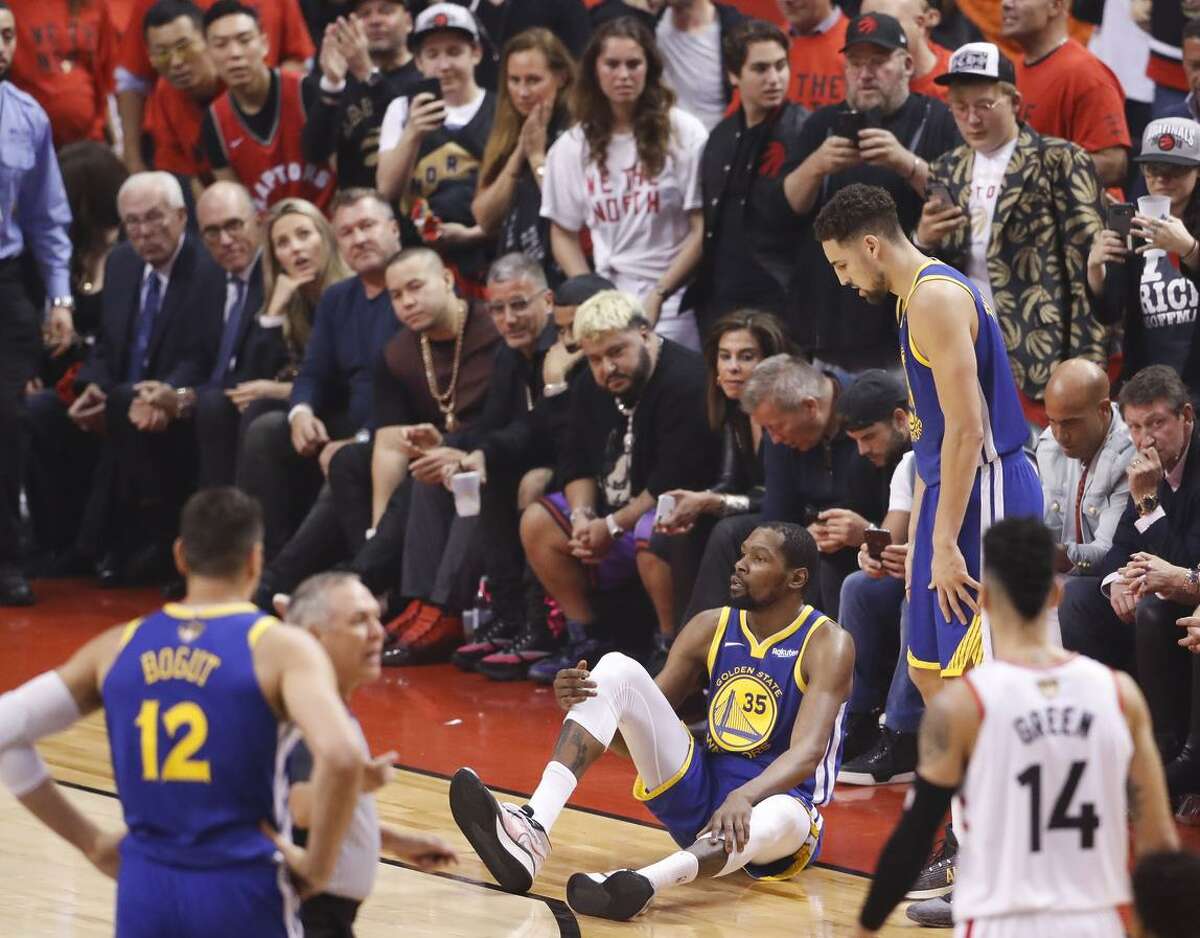 Golden State Warriors’ Kevin Durant sits on the floor after sustaining an injury to his right leg in the second quarter during game 5 of the NBA Finals between the Golden State Warriors and the Toronto Raptors at Scotiabank Arena on Monday, June 10, 2019 in Toronto, Ontario, Canada.