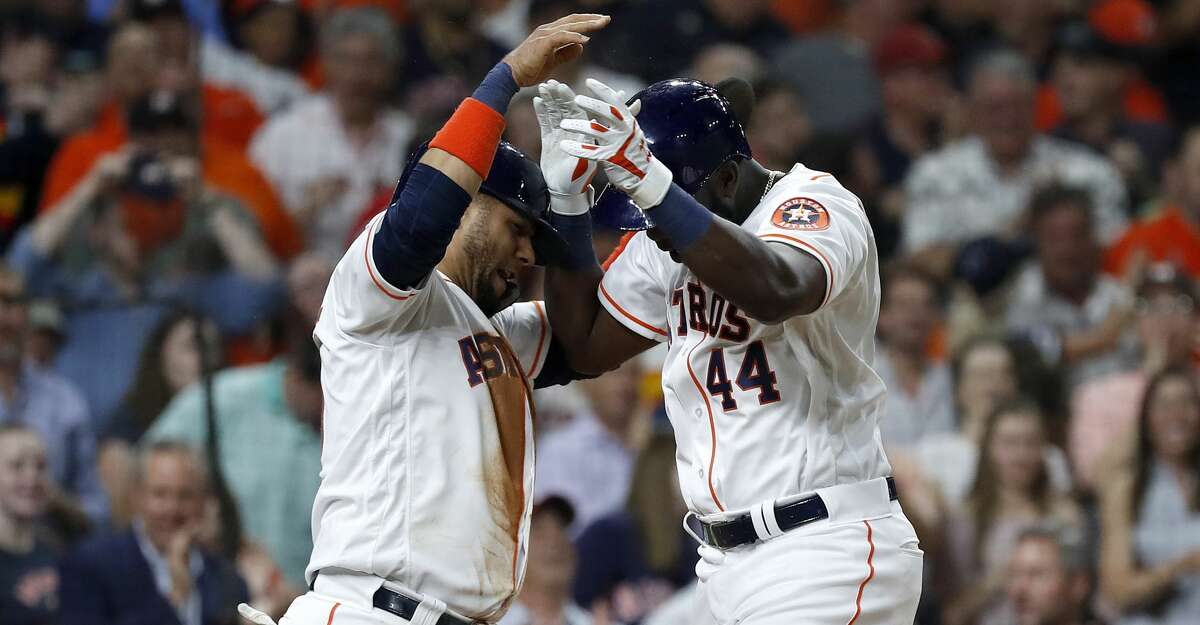 Houston Astros designated hitter Yordan Alvarez (44) celebrates his home run with Yuli Gurriel (10) during the fifth inning of an MLB baseball game at Minue Maid Park, Tuesday, June 11, 2019.