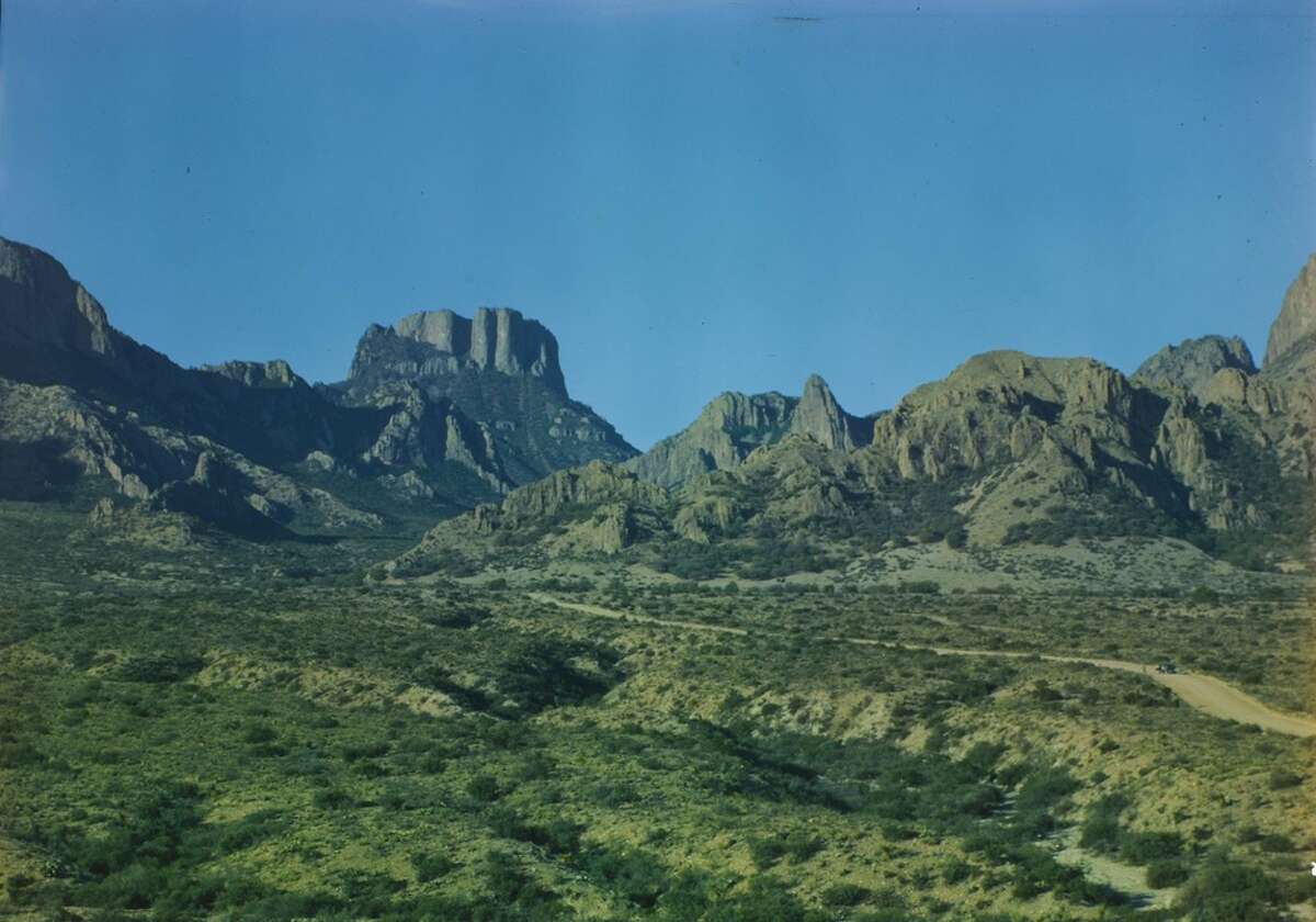 "Road into the Basin, Casa Grande Peak in distance." Natt Dodge, a park service biologist, visited the Big Bend a number of times between 1944 and 1949, and took a number of photographs while he was here. These color images provide a glimpse of the appearance and condition of Big Bend in its early years as a National Park.