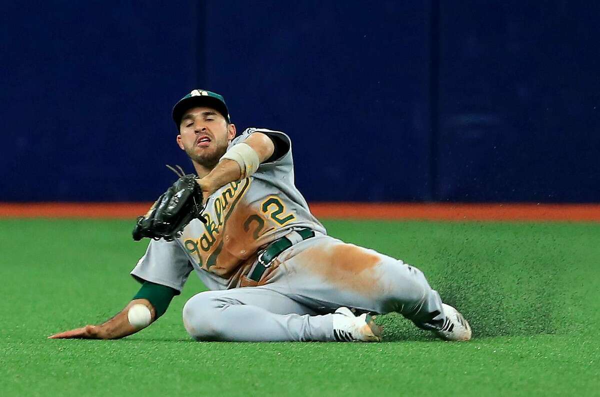 ST PETERSBURG, FLORIDA - JUNE 12: Ramon Laureano #22 of the Oakland Athletics misses a fly ball in the seventh inning during a game against the Tampa Bay Rays at Tropicana Field on June 12, 2019 in St Petersburg, Florida. (Photo by Mike Ehrmann/Getty Images)