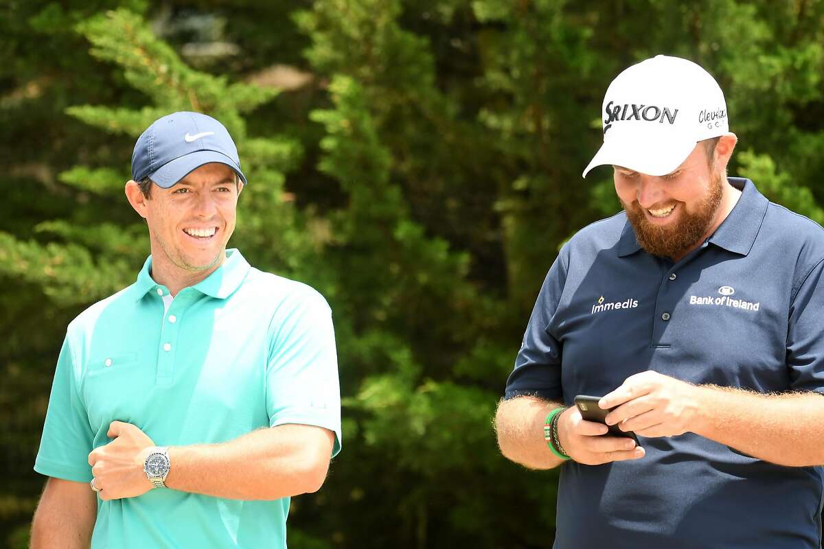 PEBBLE BEACH, CALIFORNIA - JUNE 11: (L-R) Rory McIlroy of Northern Ireland laughs with Shane Lowry of Northern Ireland during a practice round prior to the 2019 U.S. Open at Pebble Beach Golf Links on June 11, 2019 in Pebble Beach, California. (Photo by Ross Kinnaird/Getty Images)